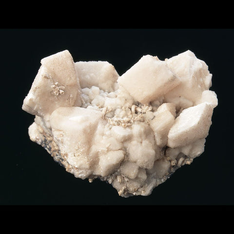 White cluster of tabular dolomite crystals on a black background