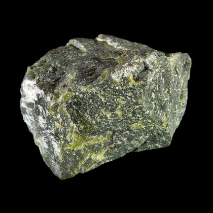 Olive green block of serpentinite on black background