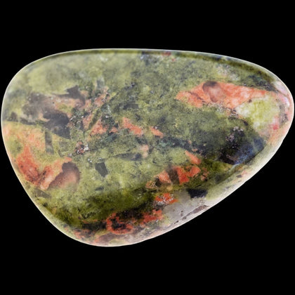 Green and pink tumbled unakite stone on black background