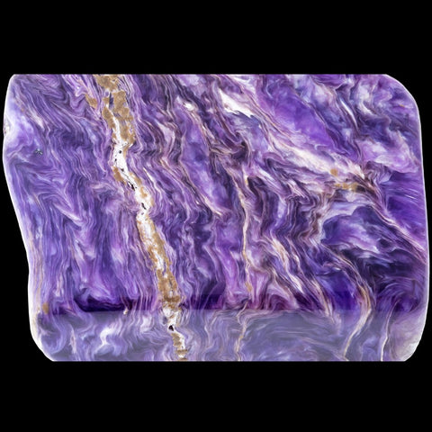 purple tumbled charoite stone on black background