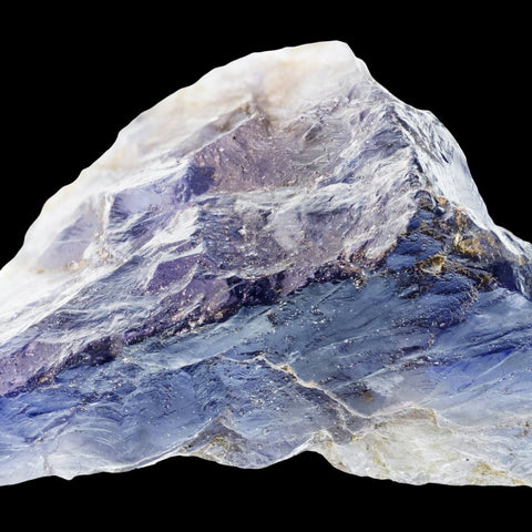 Clear to blue rough iolite crystal on black background