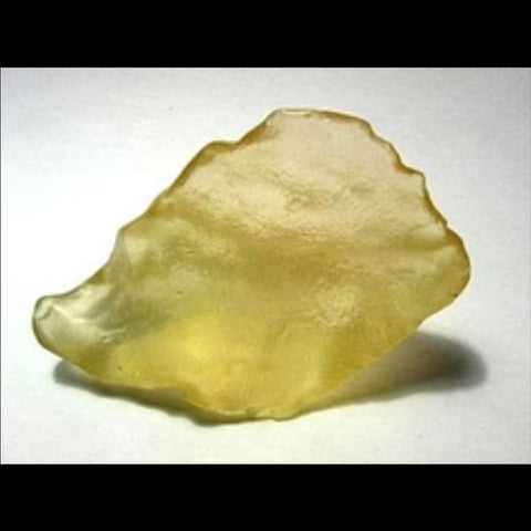 Natural Yellow Meteor Glass Blob from Libyan Desert on a white background