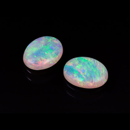 Two polished oval opals from Australia which show a rainbow of sparking colors 