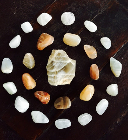 raw moonstone chunk in the center of two circles of silky moonstone