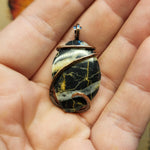 Black rock with white and orange bands from Nevada in Sterling Silver Pendant