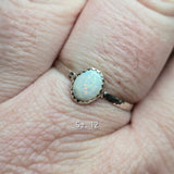 Ring with a white stone on a finger, size 12