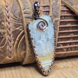 Pendant with a natural stone design on a wooden surface