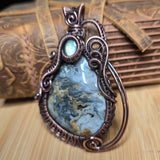 Decorative pendant with a stone on a wooden surface