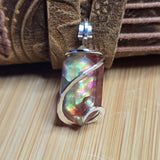 Multicolored pendant on a wooden surface
