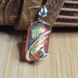 Multicolored stone pendant on a wooden surface