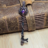 Decorative skeleton key with intricate design on a textured surface