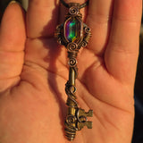 Antique skeleton key pendant with copper wire wrap and rainbow Aurora Opal.