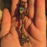 Antique skeleton key pendant with copper wire wrap and rainbow Aurora Opal.