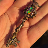 Antique skeleton key pendant with copper wire wrap and rainbow Aurora Opal.