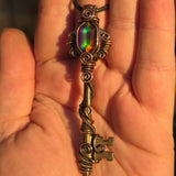 Antique skeleton key pendant with copper wire wrap and rainbow Aurora Opal.