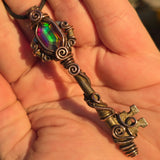 Antique skeleton key pendant with copper wire wrap and rainbow Aurora Opal.