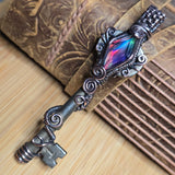 Antique number 1 skeleton key pendant with rainbow Aurora Opal and copper wire wrap.