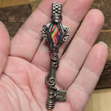 Antique number 1 skeleton key pendant with rainbow Aurora Opal and copper wire wrap.