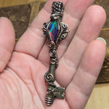 Antique number 1 skeleton key pendant with rainbow Aurora Opal and copper wire wrap.