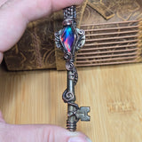 Antique number 1 skeleton key pendant with rainbow Aurora Opal and copper wire wrap.