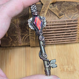Antique number 1 skeleton key pendant with rainbow Aurora Opal and copper wire wrap.