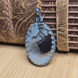 Decorative pendant with natural stone design on a textured surface