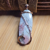 Marble-patterned pendant on a wooden surface