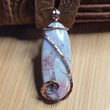 Pendant with a decorative design on a wooden surface