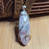 Marble-patterned pendant on a brown textured fabric background