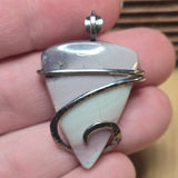 Pastel colored Jasper pendant held in hand