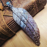 Amethyst Lace carved stone feather wrapped in sterling and rose gold fill on a leather and wood background 