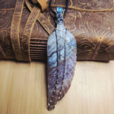 Amethyst Lace carved stone feather wrapped in sterling and rose gold fill with leather and wood background