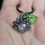 Lavender Moon Quartz pumpkin pendant wrapped in oxidized sterling silver with a green Czech glass leaf.