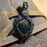 Decorative pendant with intricate design on a textured surface