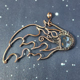 A copper wire sculpture of a meteor against a space background