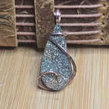Sparkly pendant on a wooden surface with a textured brown background