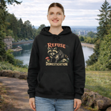 Person wearing a black hoodie with a raccoon graphic and text in a natural setting