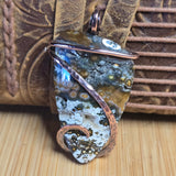 Decorative pendant with natural stone design on a textured surface
