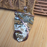 Pendant with natural stone design on a wooden surface