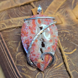 Decorative pendant with floral pattern on a textured surface