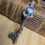 Decorative key pendant against a neutral background