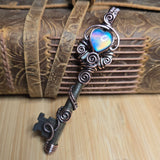 Decorative key pendant against a neutral background