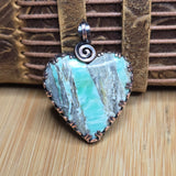 Heart-shaped variscite pendant with a spiral design on a leather strap.