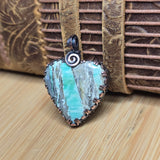 Necklace with a green stone pendant on a textured surface