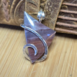 Purple Mauve Jasper pendant with a wooden background