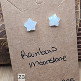 Star-shaped rainbow moonstone earrings on a brown card with 'Rainbow Moonstone' text.