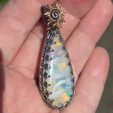 Plume Agate pendant with colorful backing in sterling silver mount. 
