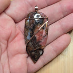 Pink Rhodonite Pendant – Forged Embrace in Rose Gold-Filled Wire - Rock Your World 